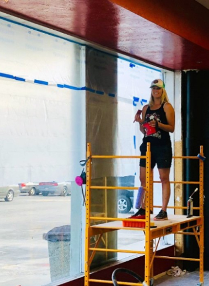 Professor Andrea Warner doing some painting on Gracie Barra Salt Lake City's construction