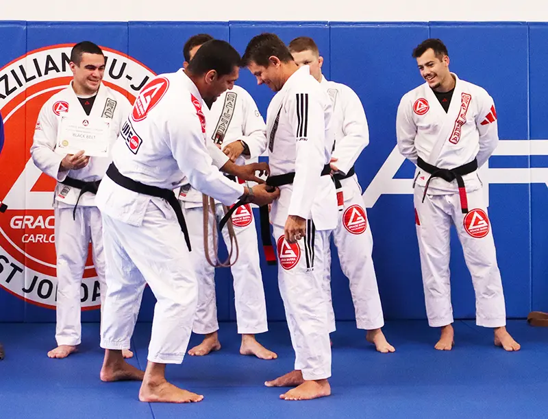 Prof. Gabriel Weinem receiving his black belt from Prof. Seidler Rodrigo
