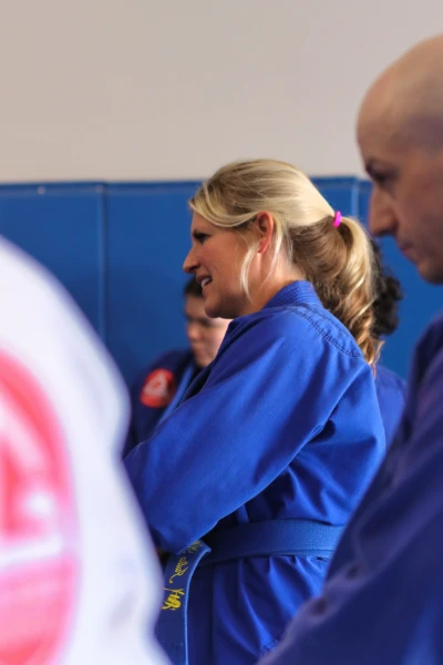 Woman training Brazilian Jiu-Jitsu against a larger partner at Gracie Barra Riverton