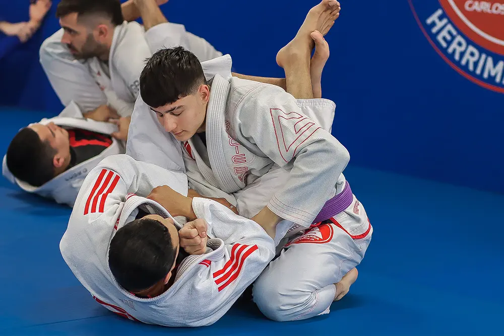 Two students training Jiu-Jitsu on the mat at Gracie Barra Herriman